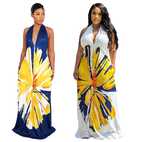 Two women wearing halter neck maxi dresses with yellow and blue abstract patterns on a white background.