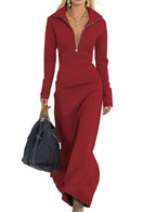 Woman in a red outfit holding a black bag on a neutral background