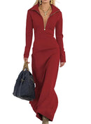 Woman in a red outfit holding a black bag on a neutral background