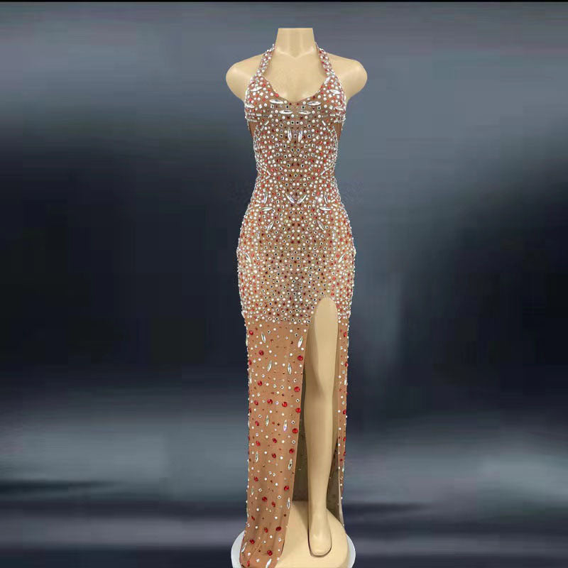 Elegant evening gown with beaded details on a mannequin against a dark background