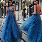Woman wearing a blue evening gown with a city street background
