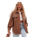 Woman wearing a brown jacket and light blue jeans in an urban setting