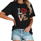 Person wearing a black t-shirt with colorful 'LOVE' graphic design outdoors.