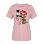 Person wearing a pink t-shirt with 'LOVE' graphic design outdoors.