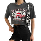 Person wearing a black t-shirt with 'California Adventure Life' design and a zebra print bag.