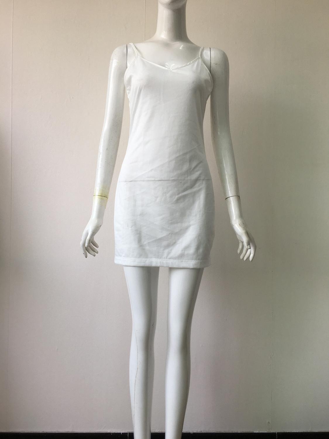 White dress on a mannequin against a plain background