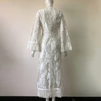 White lace dress on a mannequin against a plain background