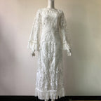 White lace dress on a mannequin against a plain background