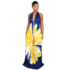 Woman wearing a blue dress with a yellow and white abstract pattern on a white background