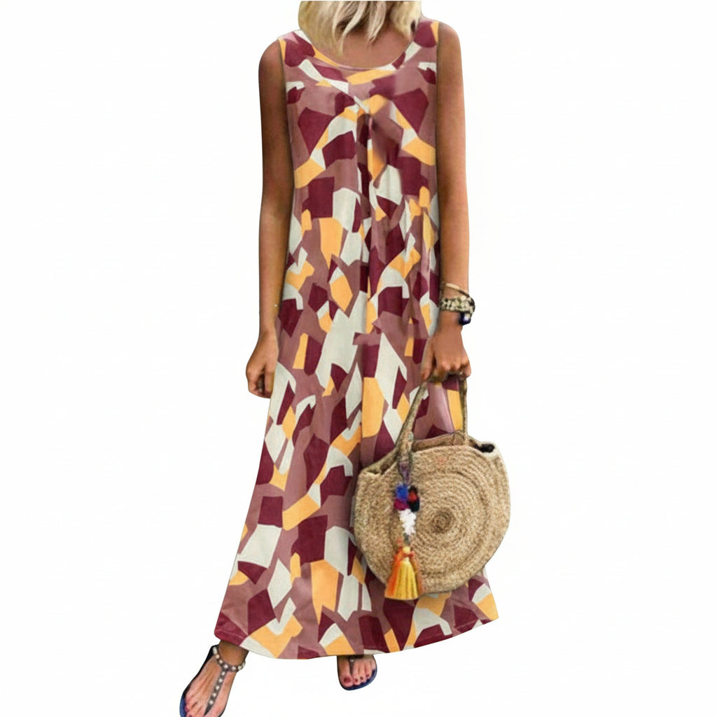 Woman wearing a patterned dress holding a round straw bag against a stone wall.