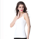 Woman wearing a white sleeveless top on a white background